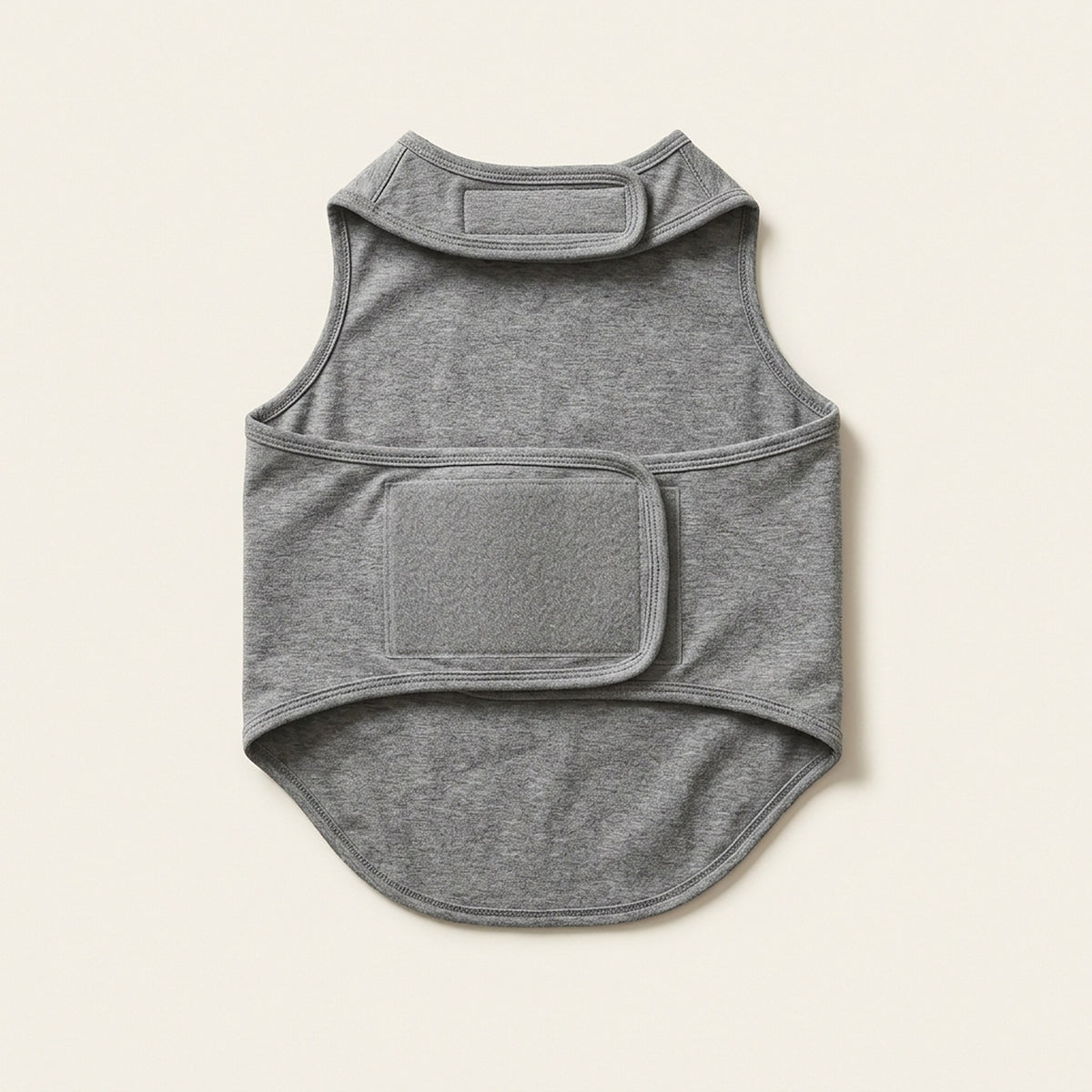 Heather grey sleeveless compression wrap for dogs, laid flat, showing the wide velcro closure panel across the torso
