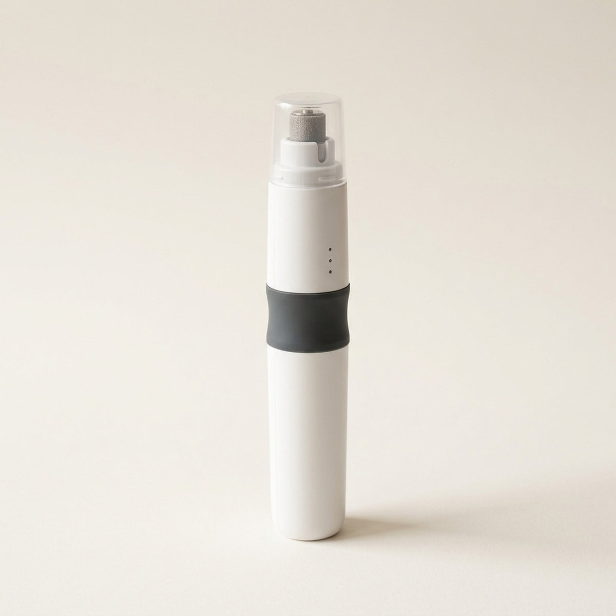 Slim white cordless pet nail grinder standing upright, with grey grip band, rotating grinding head and clear guard cap