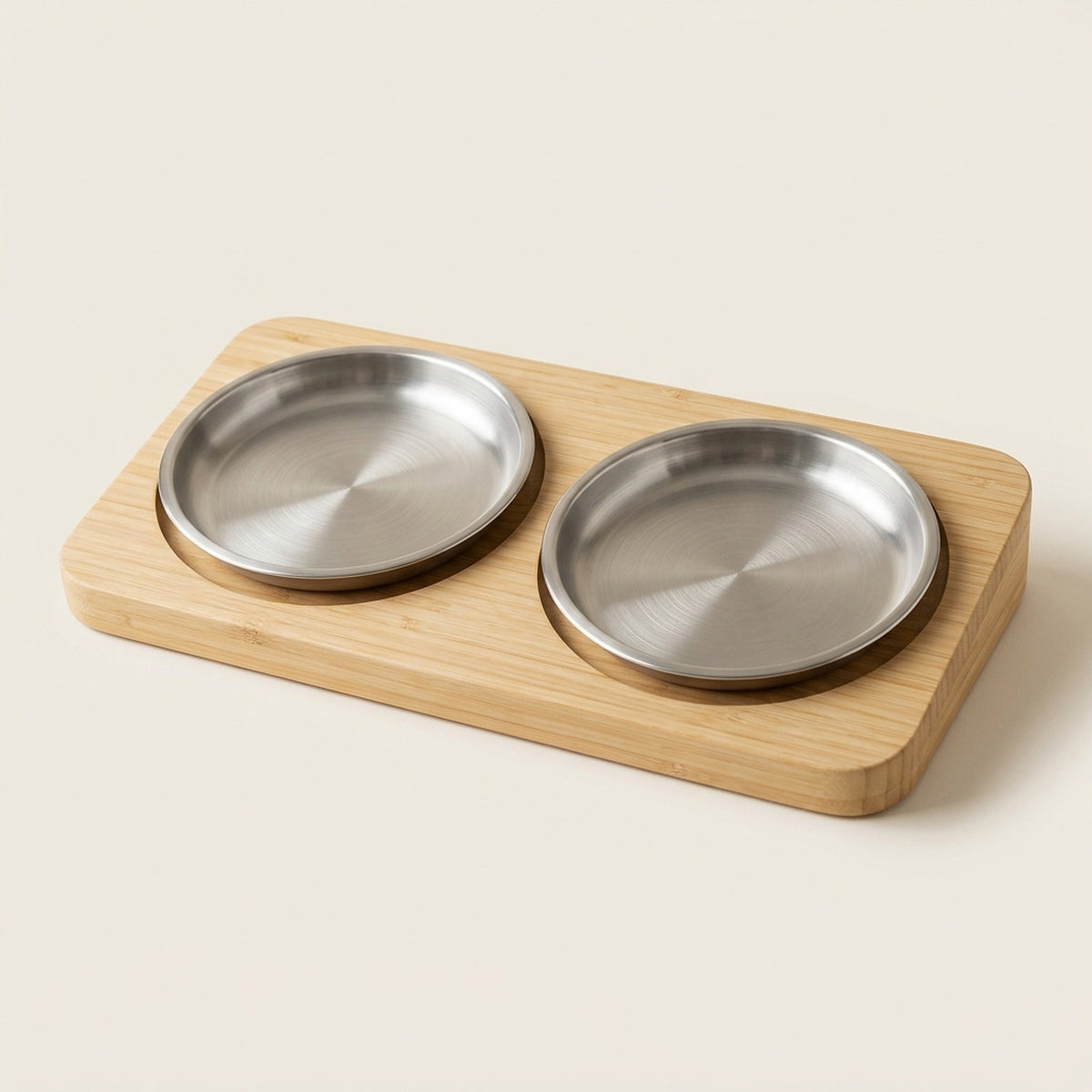 Two wide shallow stainless steel cat dishes set into a tilted bamboo stand, shallow enough that a cat's whiskers stay clear of the rim